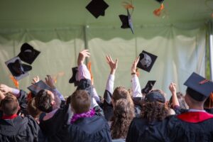College students throwing their caps in the air at the graduation ceremony